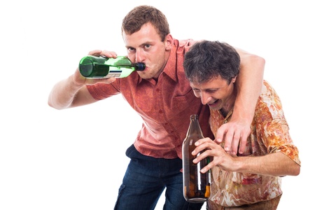 Two funny drunken men with bottle of alcohol, isolated on white backgroundの写真素材