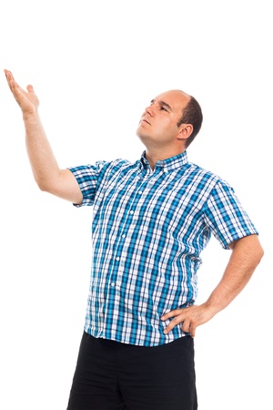 Serious pensive man looking and pointing up, isolated on white backgroundの写真素材
