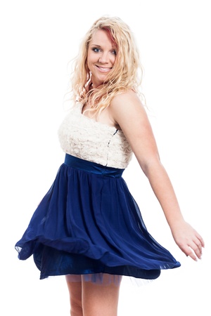 Young blond happy woman dancing, isolated on white backgroundの写真素材