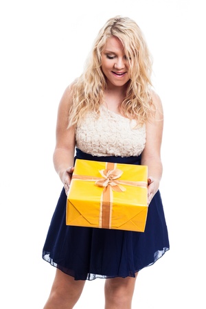 Portrait of happy surprised woman holding yellow gift box, isolated on white backgroundの写真素材