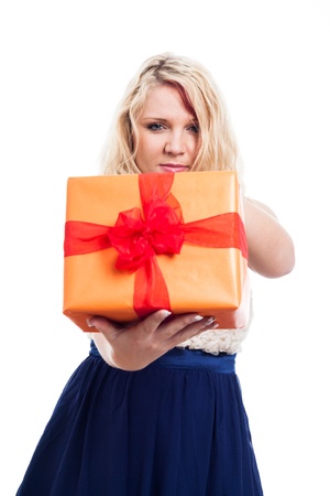 Portrait of serious woman holding orange gift box, isolated on white backgroundの写真素材