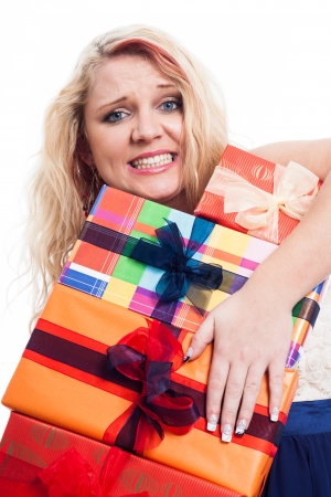 Desperate woman holding many colorful gift boxes, isolated on white backgroundの写真素材