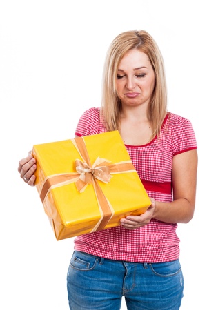 Disappointed woman holding present, isolated on white background の写真素材