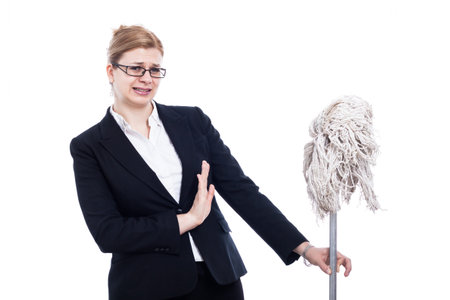 Unhappy businesswoman holding mop, isolated on white background.