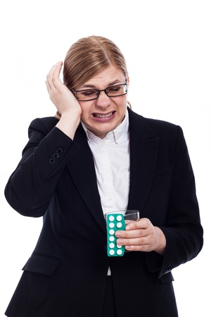 Businesswoman with migraine holding painkillers and glass of water, isolated on white background.の写真素材