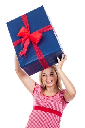 Young happy woman lifting up big present, isolated on white background.の写真素材