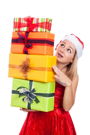 Surprised Christmas woman carrying many presents, isolated on white background.の写真素材