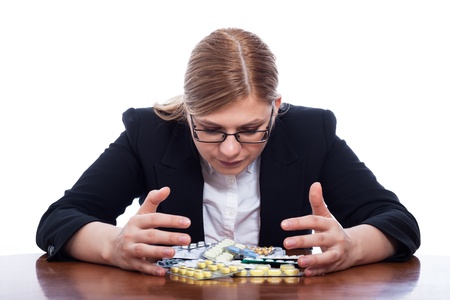 Business woman with many pills, isolated on white background.の写真素材