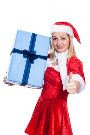 Christmas woman holding big present and showing thumb up, isolated on white background.の写真素材