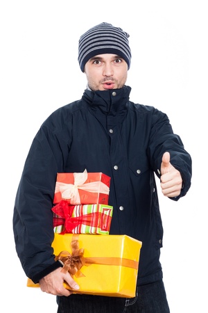 Surprised man with presents showing thumb up, isolated on white background.の写真素材