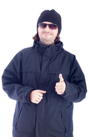 Happy man in winter clothes showing thumb up, isolated on white background.の写真素材