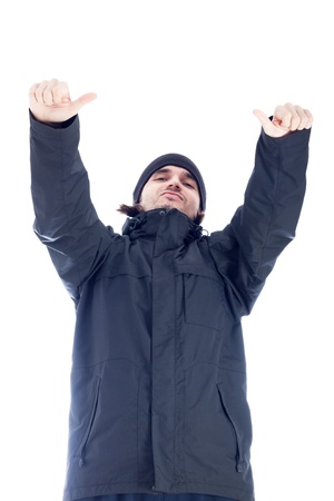 Self-confident man in winter clothes showing thumbs up, isolated on white background.の写真素材