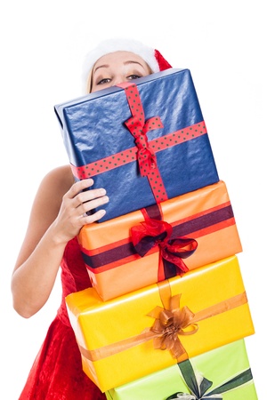 Christmas woman hiding behind many presents, isolated on white background.の写真素材