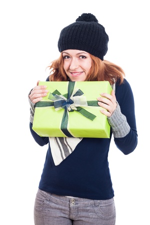 Happy winter woman holding present, isolated on white background.の写真素材