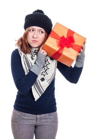 Curious winter woman holding present, isolated on white background.の写真素材