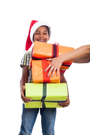 Happy child getting many Christmas presents, isolated on white background.の写真素材
