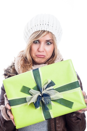Disappointed woman holding present, isolated on white background.の写真素材