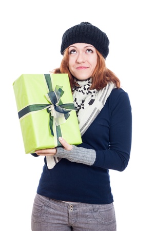 Pleased winter woman holding present, isolated on white background.の写真素材