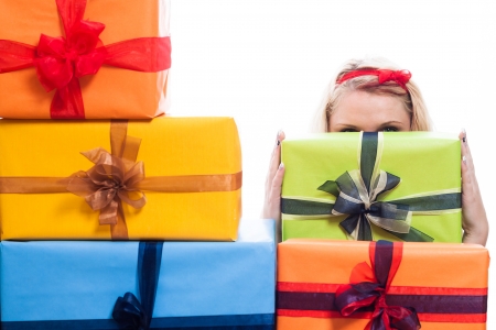 Secret woman hiding behind many presents, isolated on white background.の写真素材