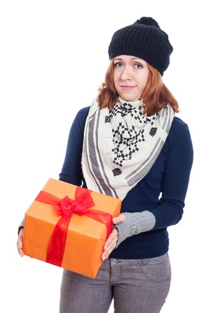 Disappointed winter woman holding present, isolated on white background.の写真素材