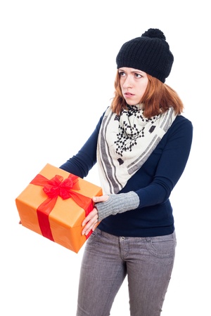 Serious winter woman holding gift box, isolated on white background.の写真素材