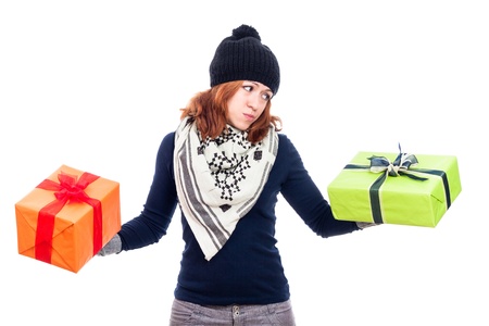Indecisive woman looking at present, isolated on white background.の写真素材