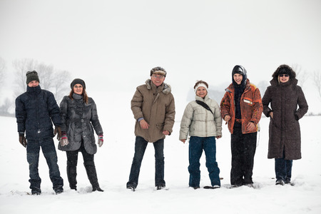 Group of happy people enjoying winter in snow.の写真素材