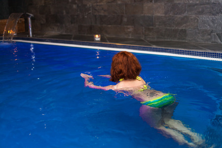 Woman in wellness and spa swimming pool.の写真素材
