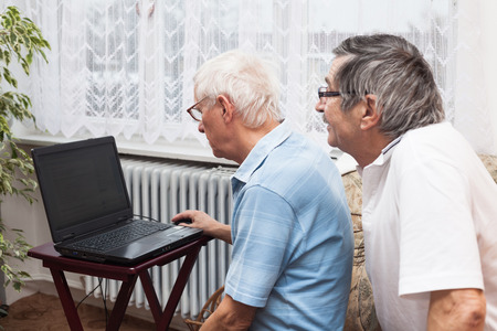 Two seniors learning to use a computer.の写真素材