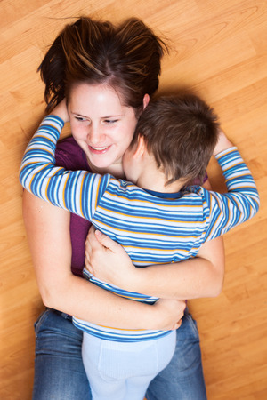 Portrait of happy mother and son huggingの写真素材