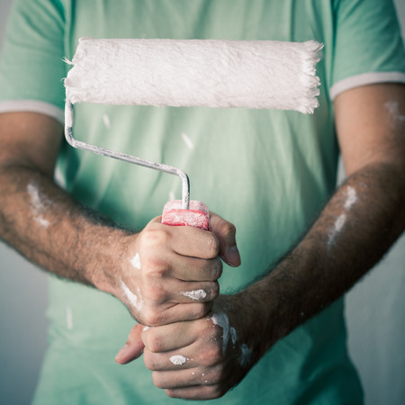 Detail of a decorator holding paint roller.の写真素材