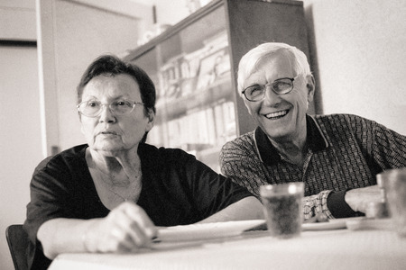 Portrait of happy senior couple indoors. Toned grainy 35mm film scan.の写真素材