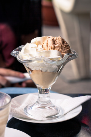 Sundae with cocoa ice cream and whipped cream の写真素材