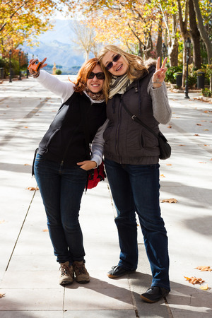 Portrait of two young happy women in parkの写真素材