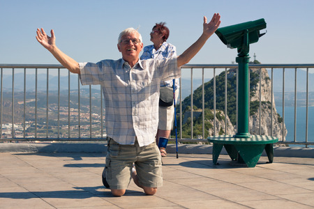 Happy hilarious senior man tourist on the top of Gibraltar Rock.の写真素材