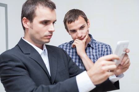 Two businessmen looking at digital tablet in the office.の写真素材
