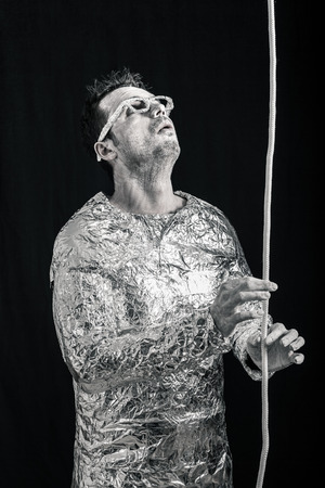 Spaceman touching rope and looking up.の写真素材