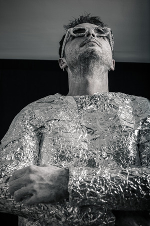 Portrait of pensive spaceman looking up.の写真素材