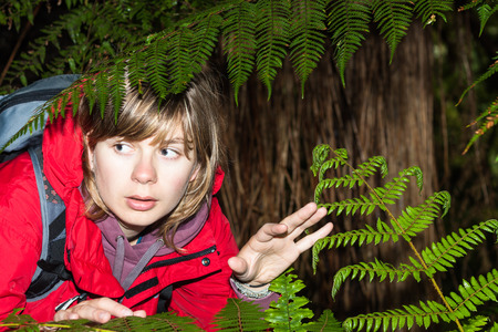 Young scared woman backpacker lost in dark forest , New Zealandの写真素材