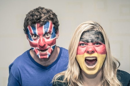 Couple of excited sports fans shouting.の写真素材