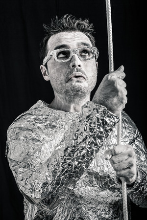 Desperate spaceman holding rope.の写真素材