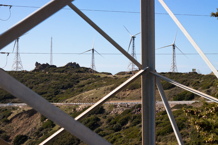 Look through electricity pole to landscape with wind turbines. Tarifa, Cadiz, Andalusia, Spain.の写真素材