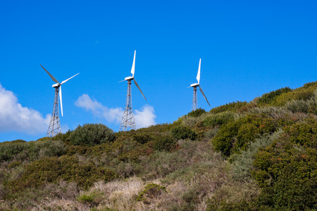Wind turbines on the green hill with blue sky. Tarifa, Cadiz, Andalusia, Spain.の写真素材