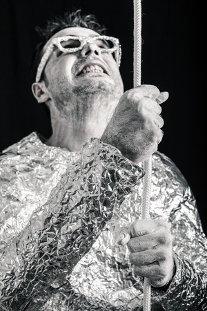 Desperate alien man holding rope.の写真素材