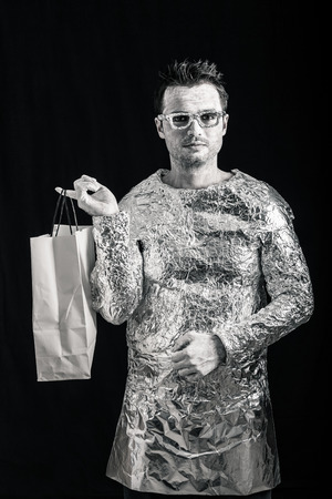 Portrait of alien man holding shopping bag.の写真素材