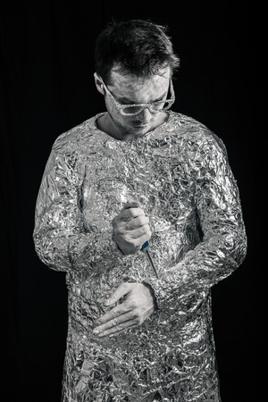 Portrait of cyborg man fixing himself with screwdriver.の写真素材