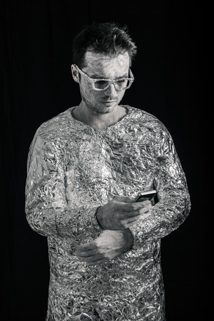 Portrait of spaceman using mobile phone.の写真素材