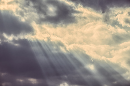 Faded sky with dark clouds and streaming lights.の写真素材