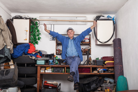 Portrait of happy satisfied senior worker enjoying work in his workshop.の写真素材