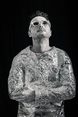Portrait of alien man looking up, over dark background.の写真素材